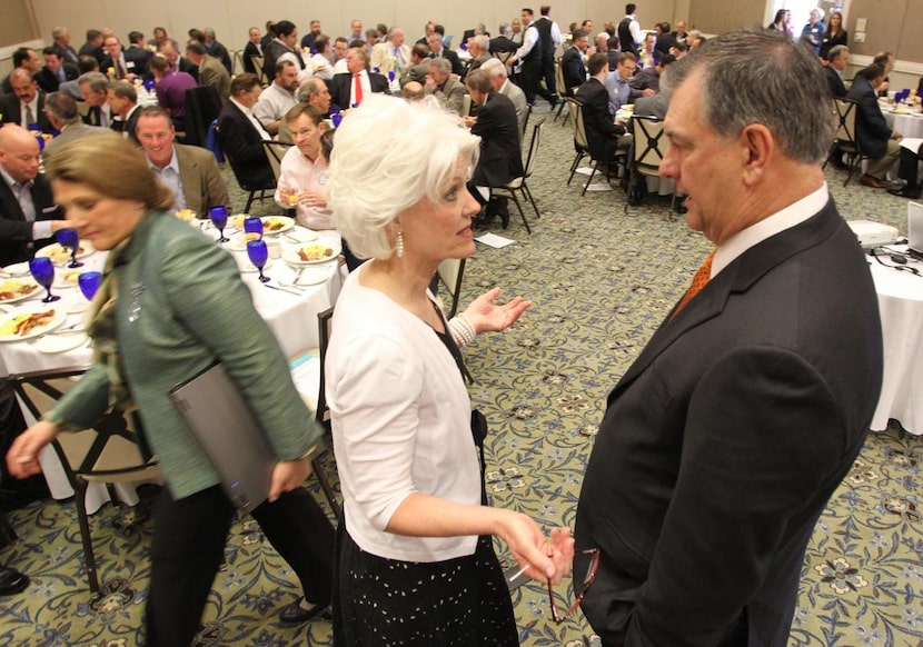 
Dallas Mayor Mike Rawlings (right) visits with Genesis Women’s Shelter executive director...