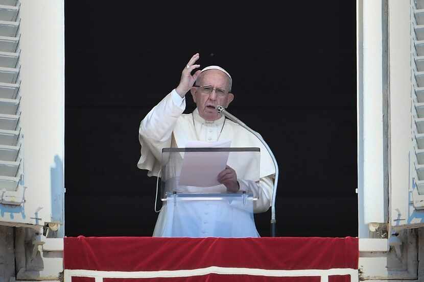 Pope Francis delivers a speech to the faithful prior to the Angelus prayer at St. Peter's...