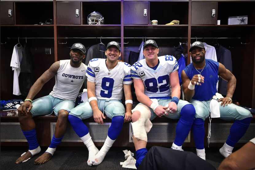 L to R: Dez Bryant, Tony Romo, Jason Witten and DeMarco Murray celebrate clinching the 2014...