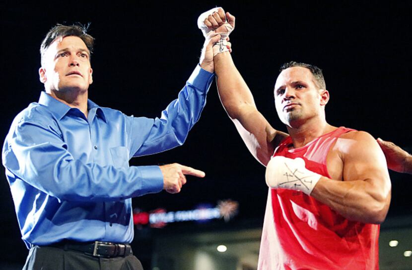 Mike Tufariello Jr. (right), 38, of Carrollton, is announced as the winner by the referee...