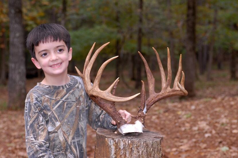 #1 (Lukas Bass with big buck) Lukas Bass, 7, displays the rack of a 16 point non-typical he...