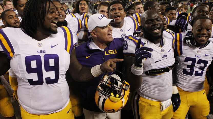 LSU Tigers head coach Les Miles joins his team in singing the school song following a 37-27...