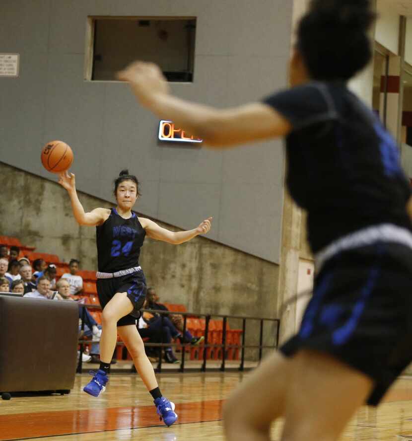 Plano West's Natalie Chou (24) saves the ball and passes to teammate Jalyn Hodge (22) in a...