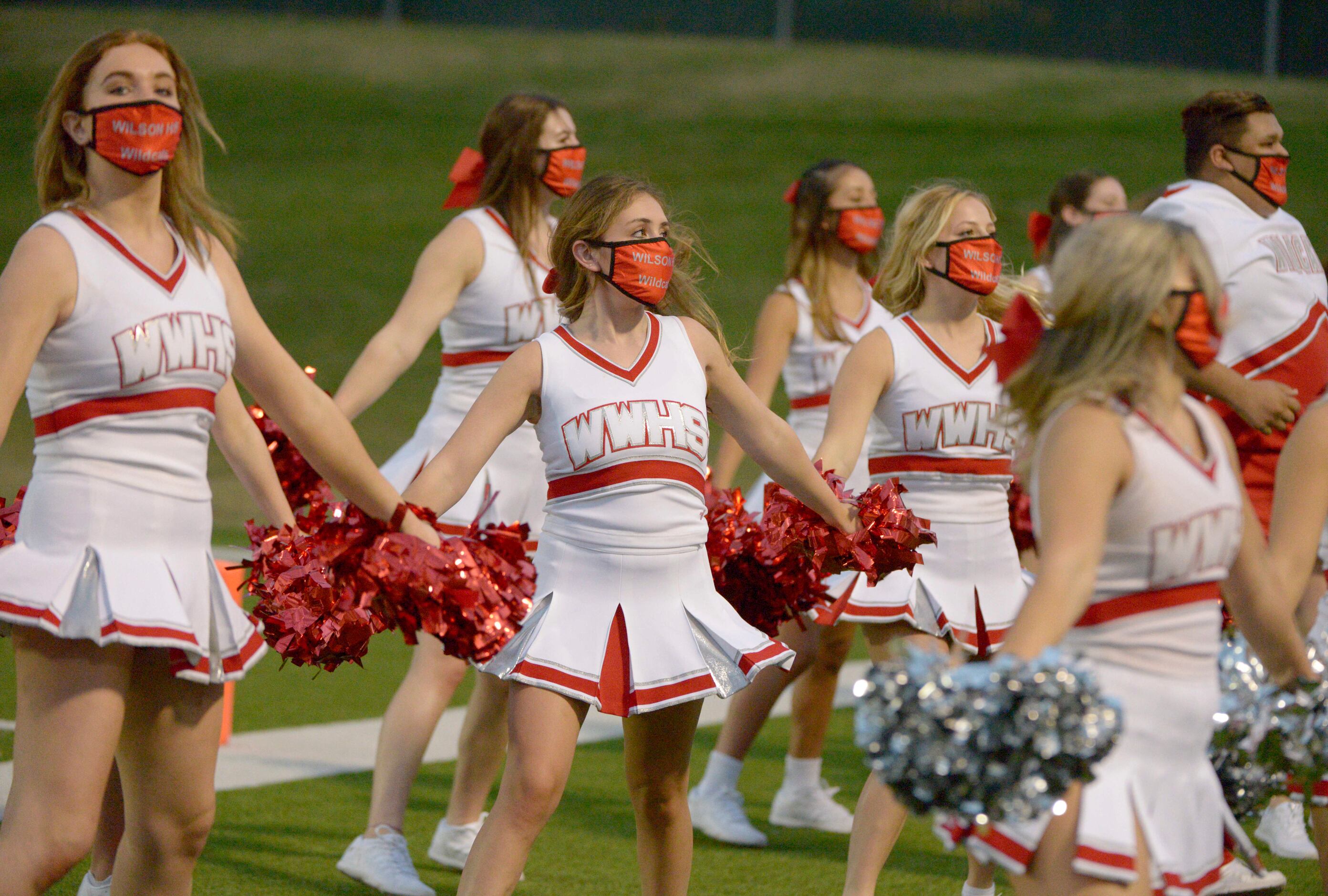 Woodrow Wilson cheerleaders perform in the first quarter of a high school football game...