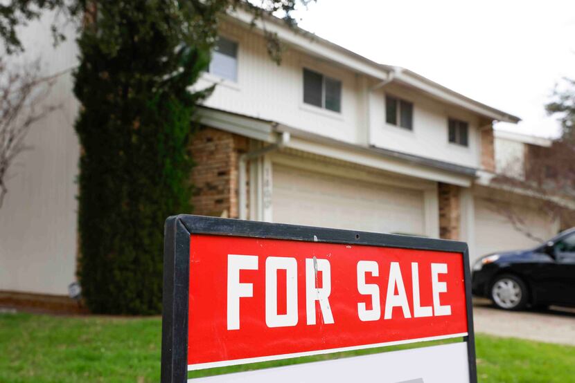 A for sale sign is displayed outside a house in Carrollton. In November, home listings were...