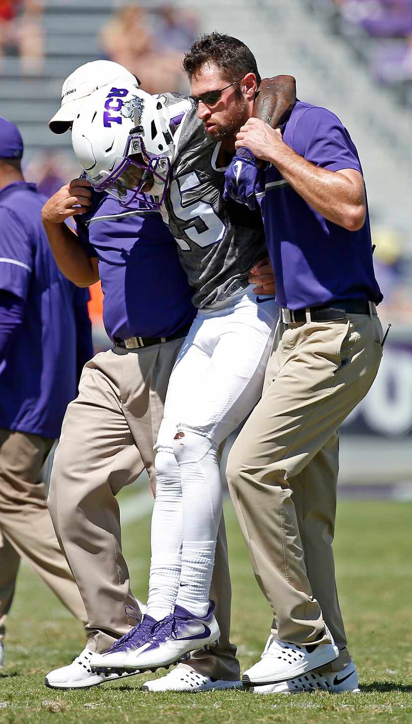 TCU wide receiver KaVontae Turpin (25) is helped to get off the field after he injured his...