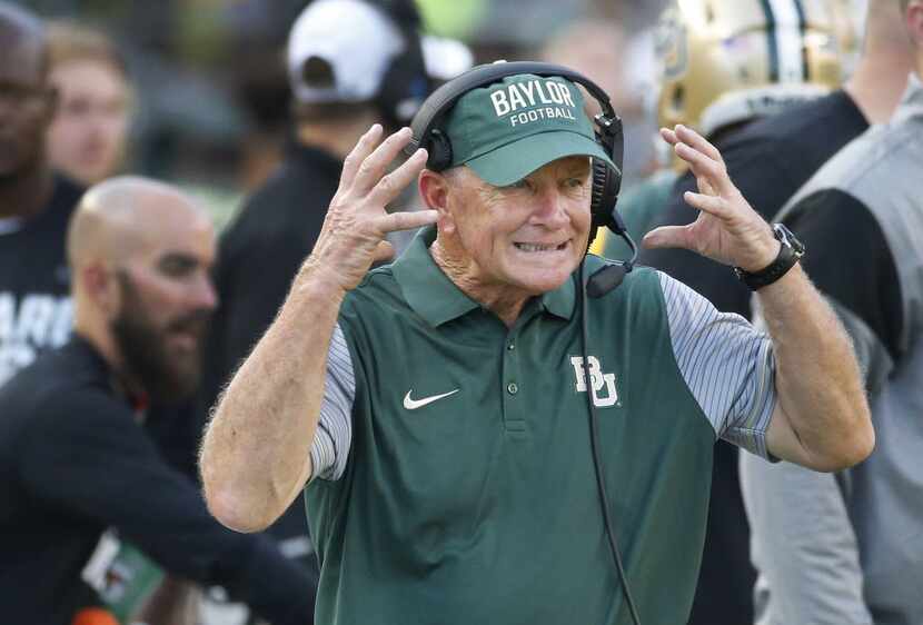 Baylor acting head coach Jim Grobe rects along the sidelines in the first quarter during the...