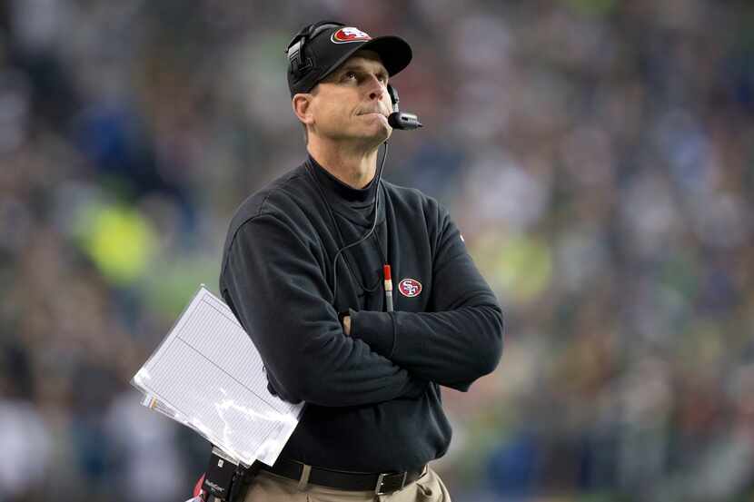 Jim Harbaugh 49ers head coach looks at the scoreboard as the Seahawks go to a 23-17 victory...