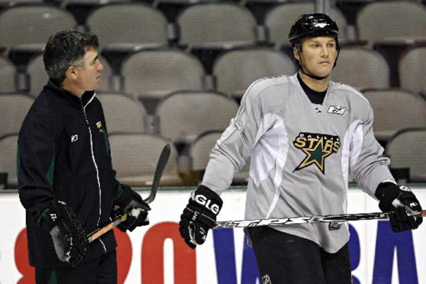 Dallas Stars head coach Dave Tippett (left) talks with Sean Avery during morning practice...