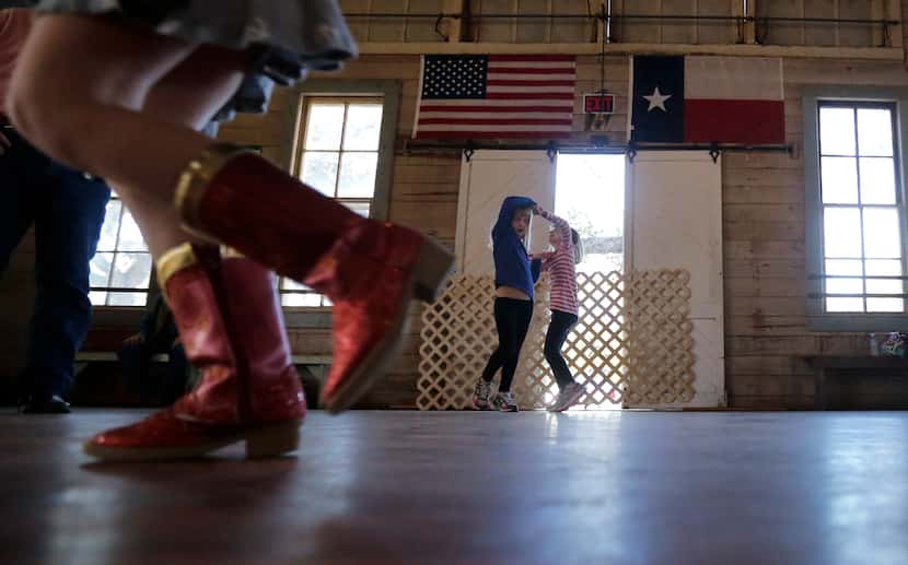 In this Dec. 6, 2014, photo, girls dance to fiddle music at Twin Sisters Dance Hall in...
