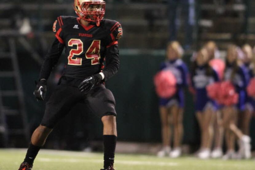 South Grand Prairie defensive back Jason Hall (24) smiles at a teammate after knocking down...