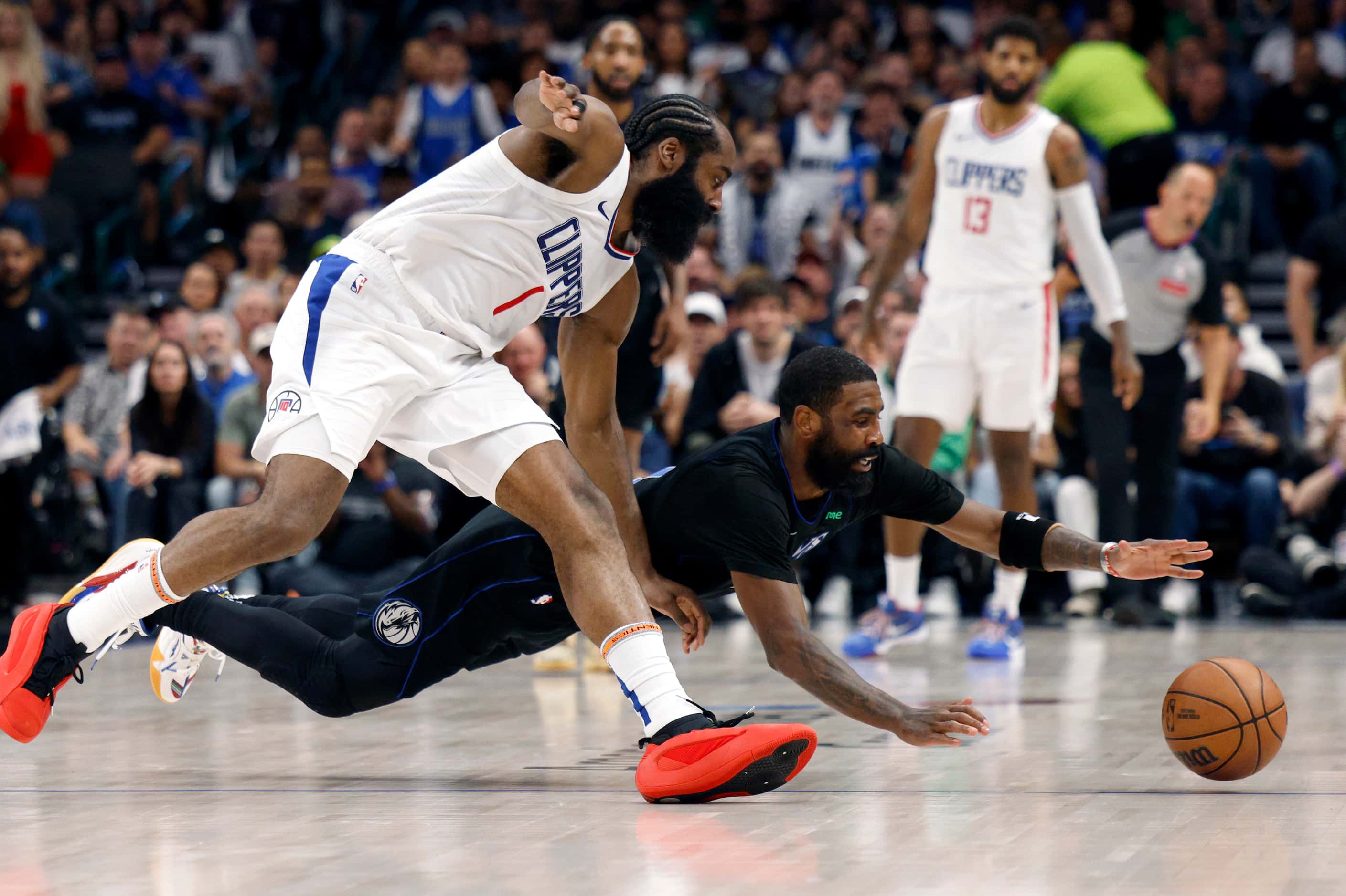 Dallas Mavericks guard Kyrie Irving (11) dives to the floor for a loose ball against LA...