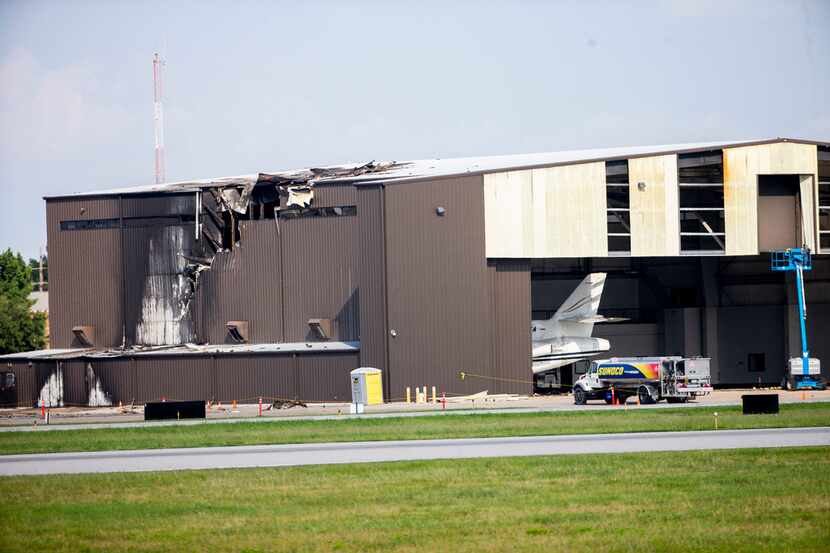 A hangar was badly damaged when a twin-engine plane crashed into it Sunday morning at...
