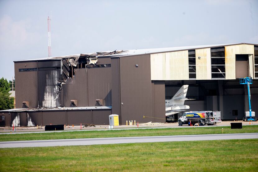 A hangar was badly damaged when a twin-engine plane crashed into it Sunday morning at...