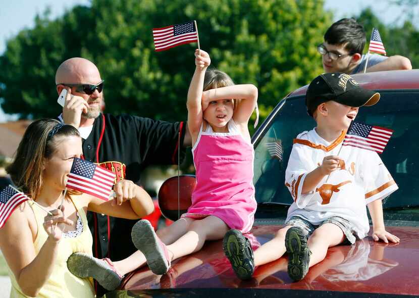 
Onlookers waved during the parade to open the “Welcome Home” event for Vietnam War veterans...