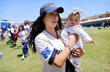 Dallas Cowboys quarterback Dak Prescott’s girlfriend Sarah Jane Ramos carries their daughter...