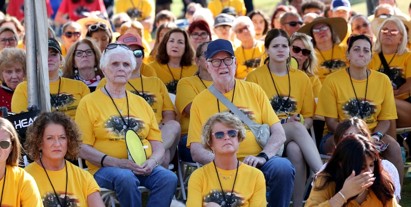 Friends and family members listen intently to a story shared by First HELP president Karen...