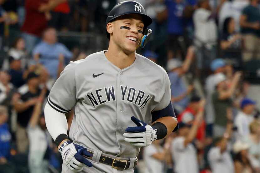 New York Yankees right fielder Aaron Judge (99) smiles after hitting a home run to left...