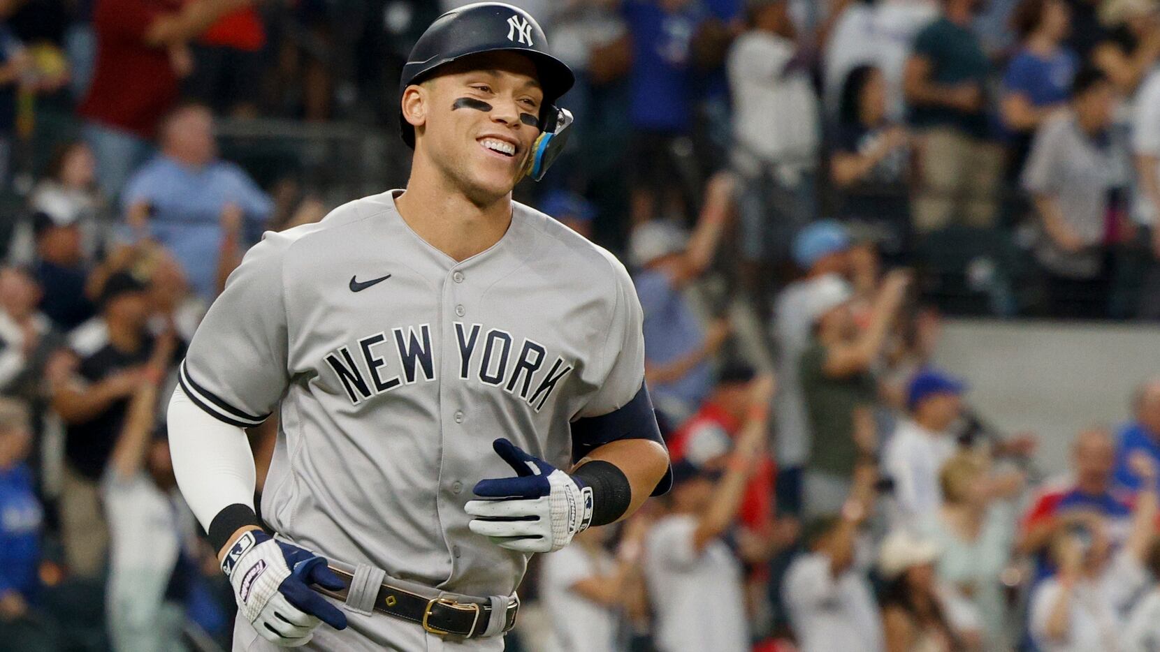New York Yankees right fielder Aaron Judge (99) smiles after hitting a home run to left...