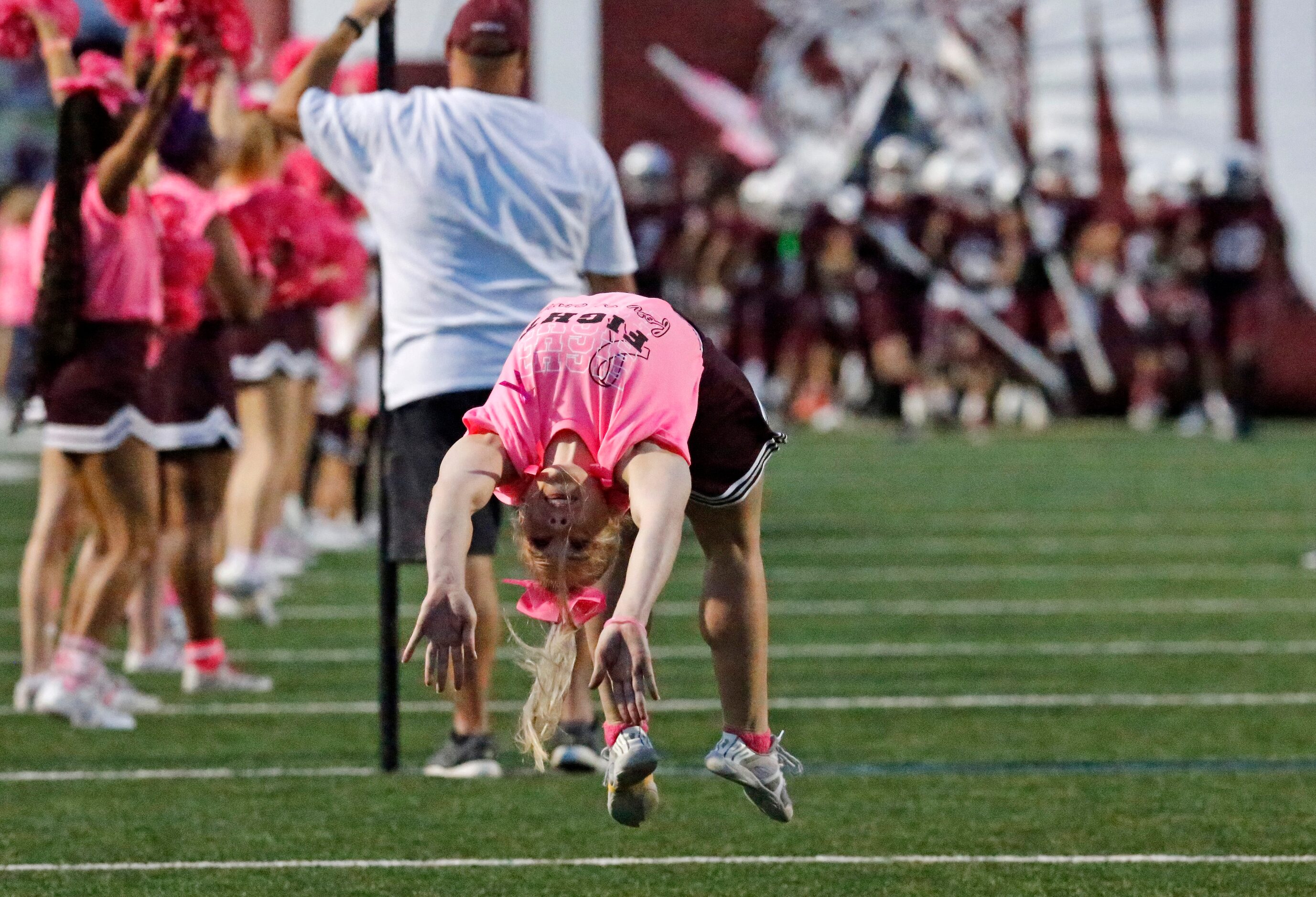 Plano cheerleader Camryn Adams does backflips ahead of the team taking the field before...