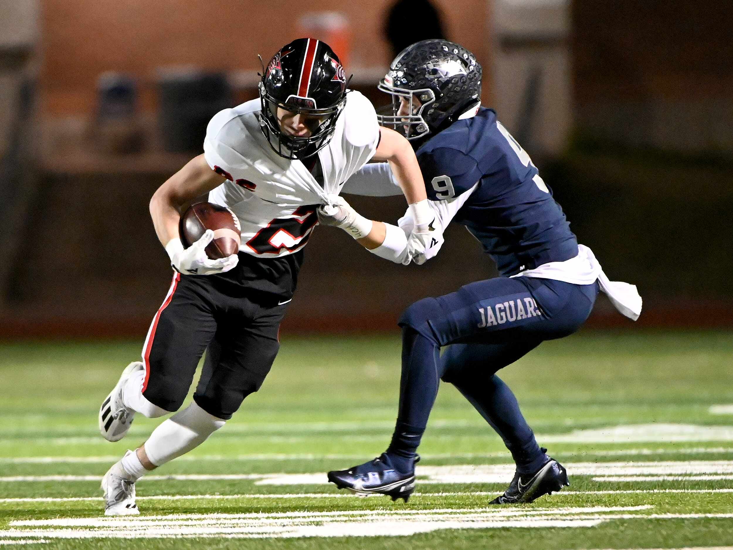 Coppell's Zack Darkoch (26) tries to get away from a tackle attempt by Flower Mound's Caleb...