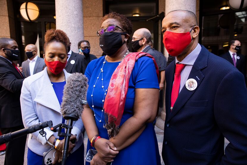 Botham Jean's mother, Allison Jean (center), stood with her husband, Bertrum Jean, and...