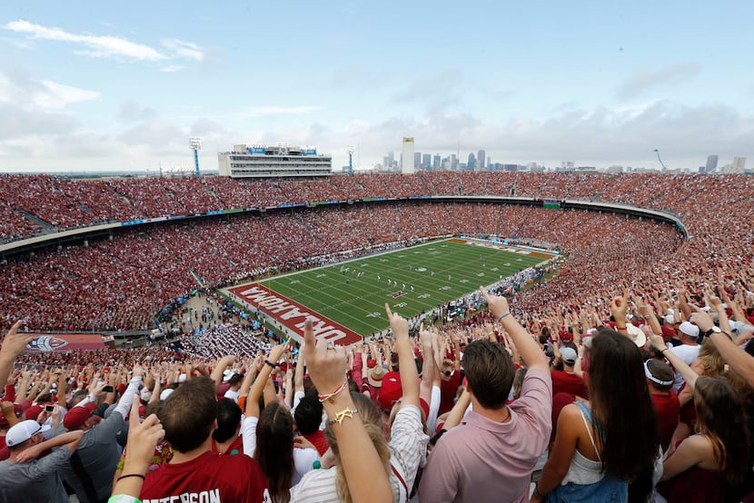 FILE - Oklahoma fans yell as Texas kicks the ball off to start the Red River Showdown...