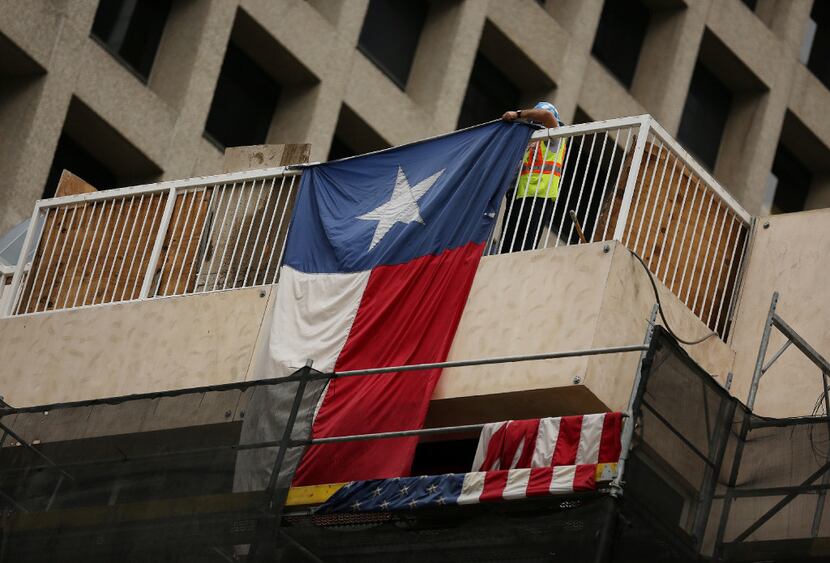 A construction worker repositions a Texas flag during development work in November at the...