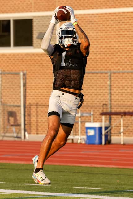Lewisville wide receiver Jaydan Hardy makes a leaping catch during the first day of practice...