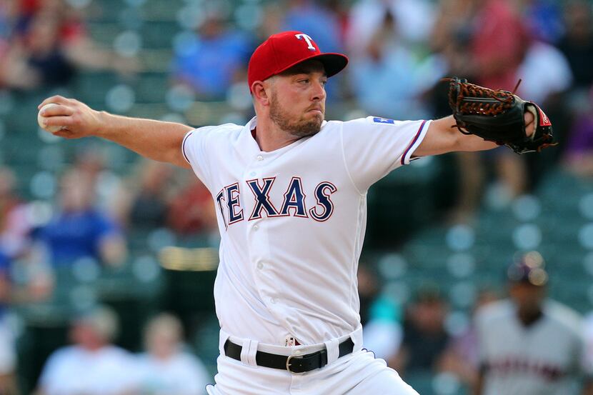 Texas Rangers starting pitcher Adrian Sampson works against the Cleveland Indians in the...