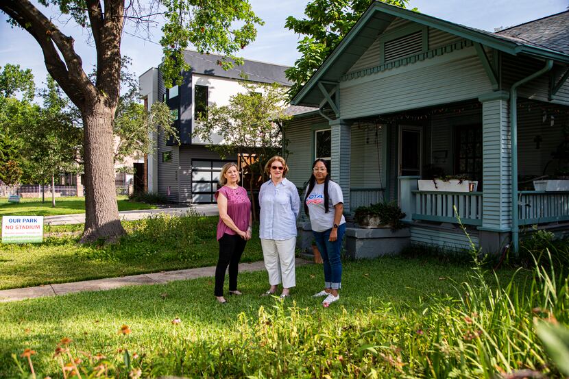 Jeanne Chvosta (from left), Karen Roberts and Sarah Mendoza in front of Roberts' home in the...