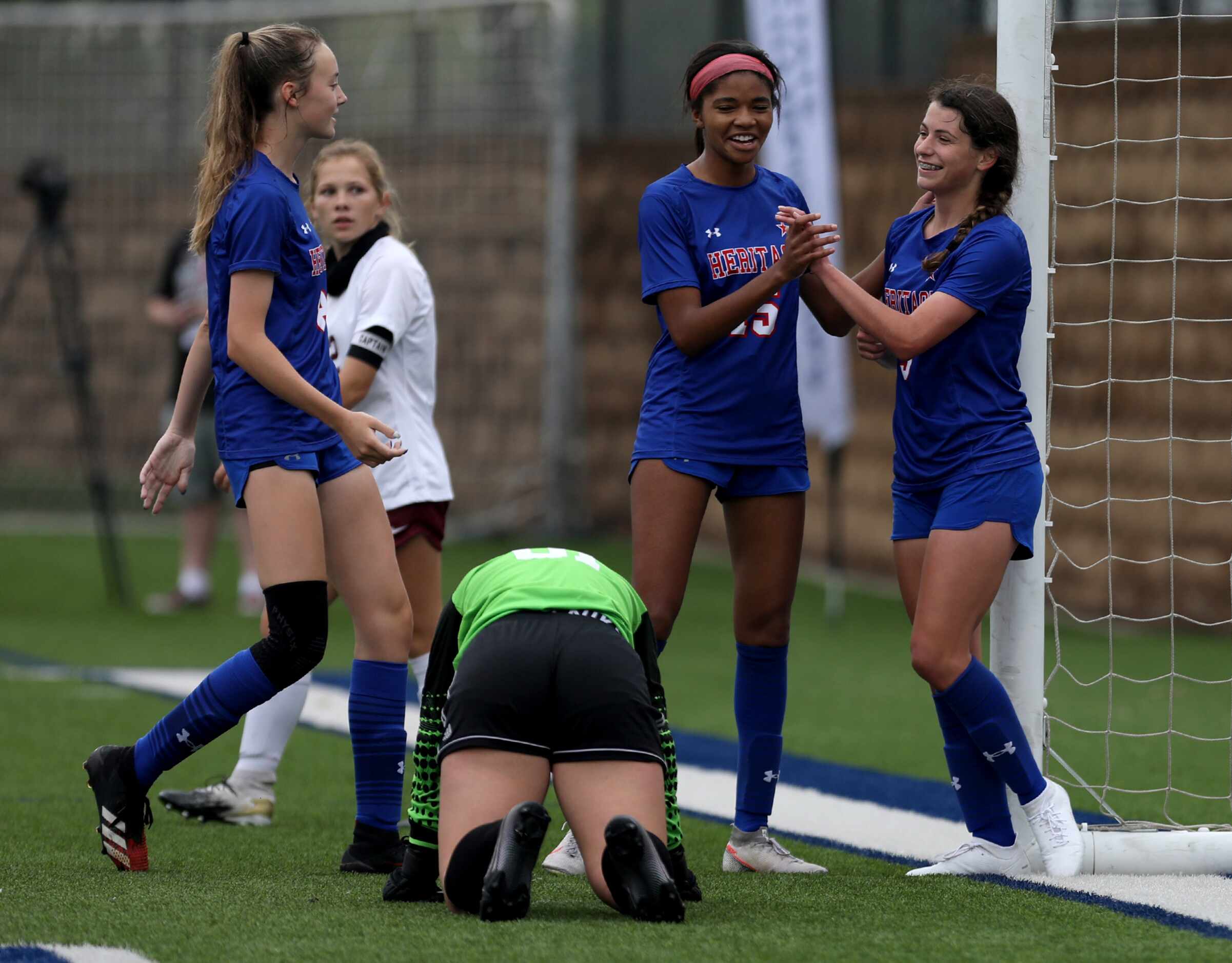 Midlothian Heritage players celebrate as they make another goal against Calallen during...