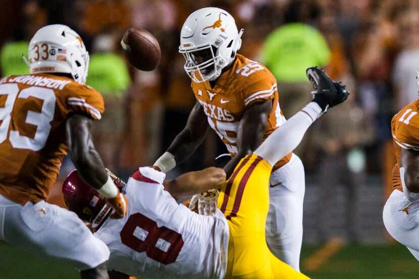 FILE - Texas defensive back B.J. Foster (25) tackles USC wide receiver Amon-Ra St. Brown...