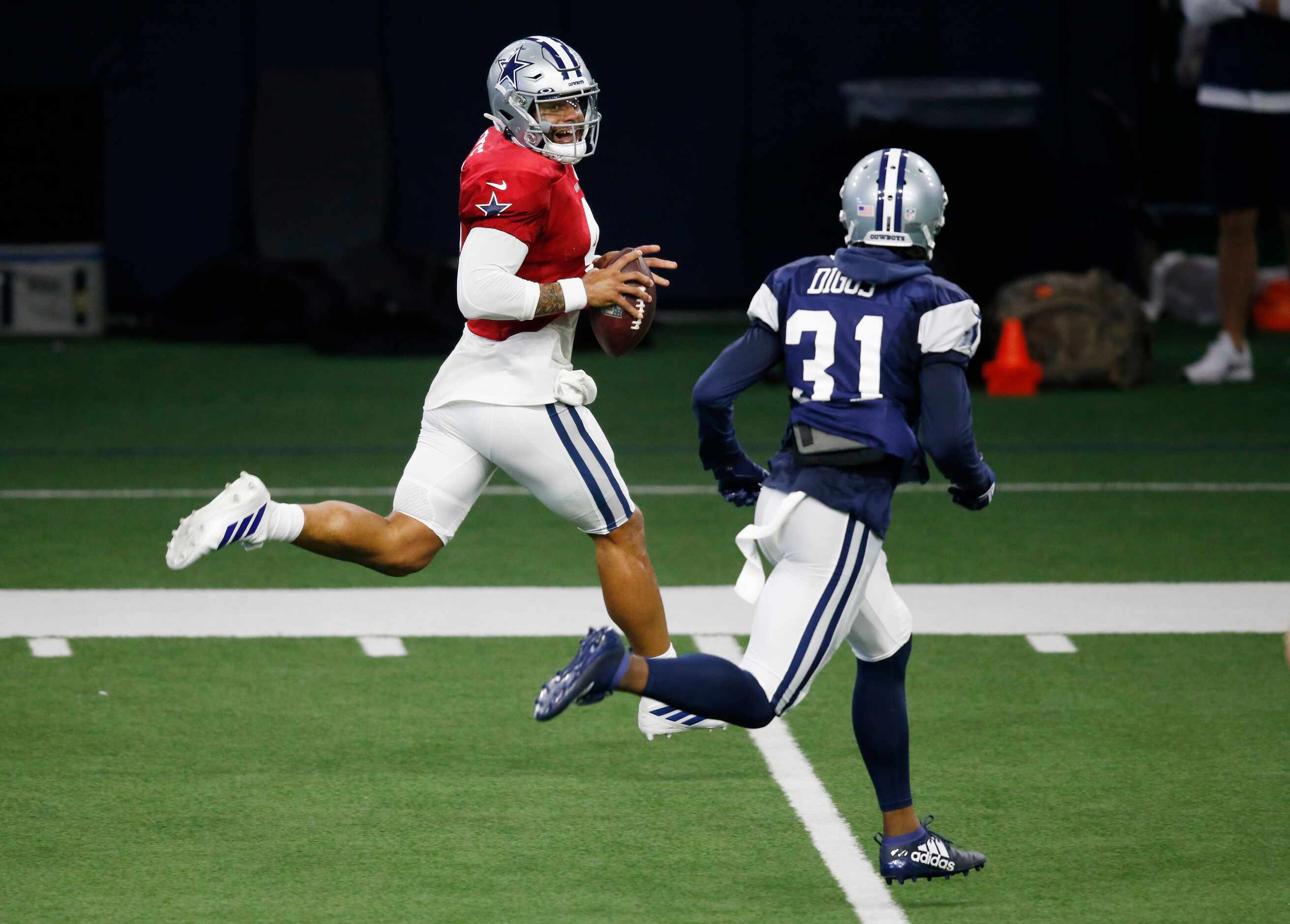Dallas Cowboys quarterback Dak Prescott (4) rushes up the field smiling as Dallas Cowboys...