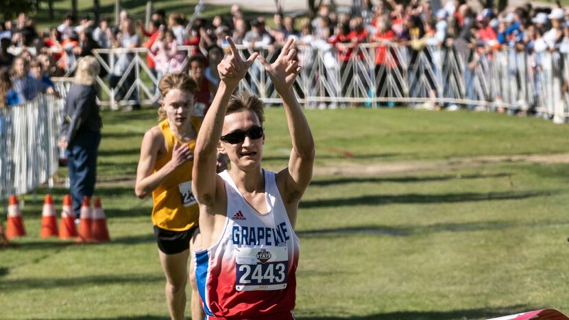 Grapevine Grapevine Walker St. John, (2443), gestures as he crosses the finish line winning...