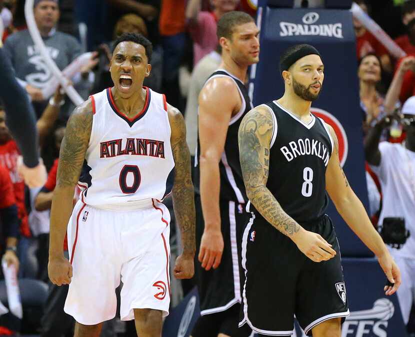 The Atlanta Hawks' Jeff Teague (0) reacts after hitting a shot against the Brooklyn Nets'...