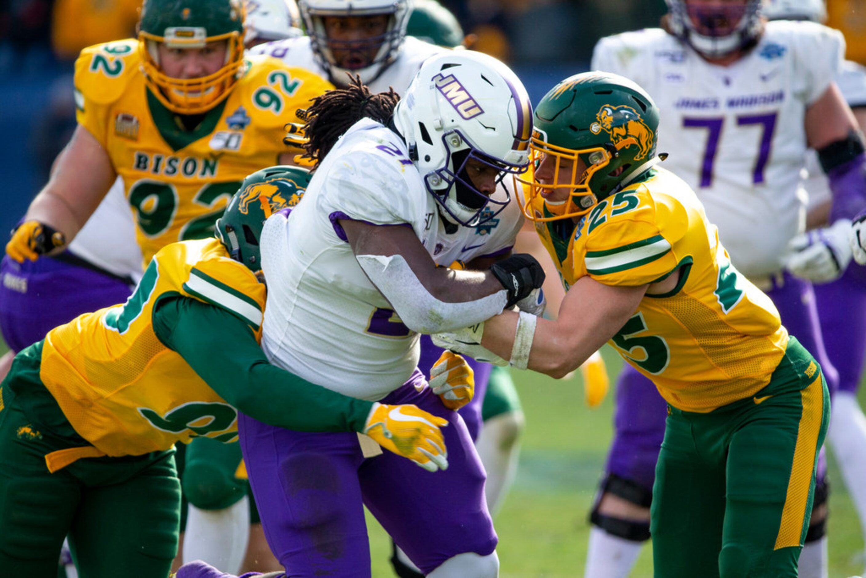 James Madison running back Latrele Palmer (21) is tackled by North Dakota State safety...