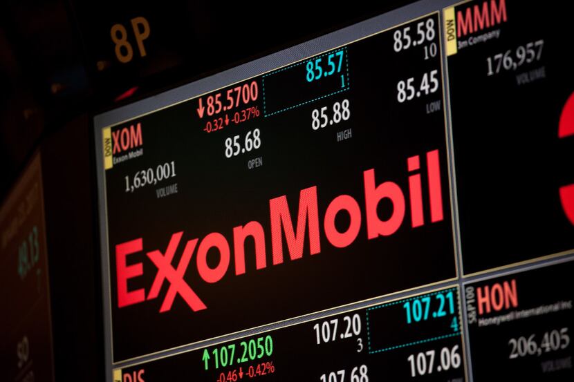 A monitor displays Exxon Mobil Corp. signage on the floor of the New York Stock Exchange...