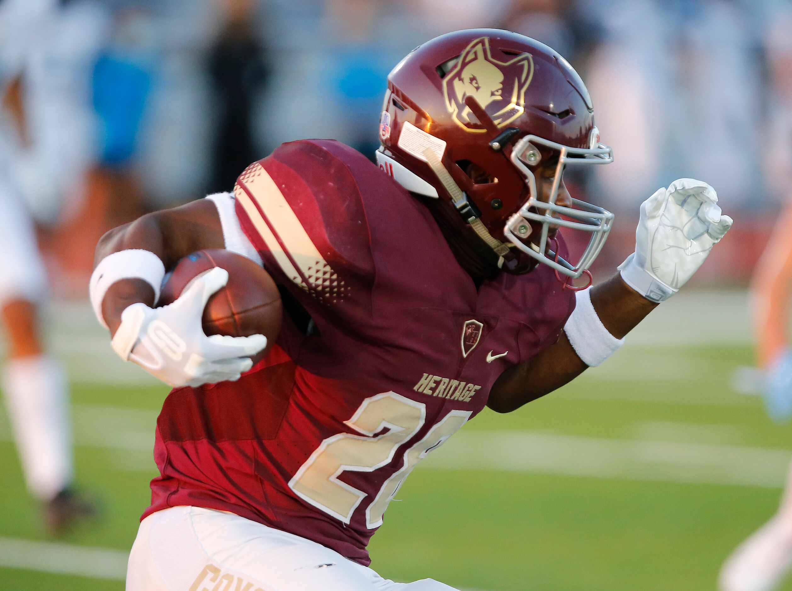 Heritage High School kick returner Shawn Wara (28) runs the ball during the first quarter as...