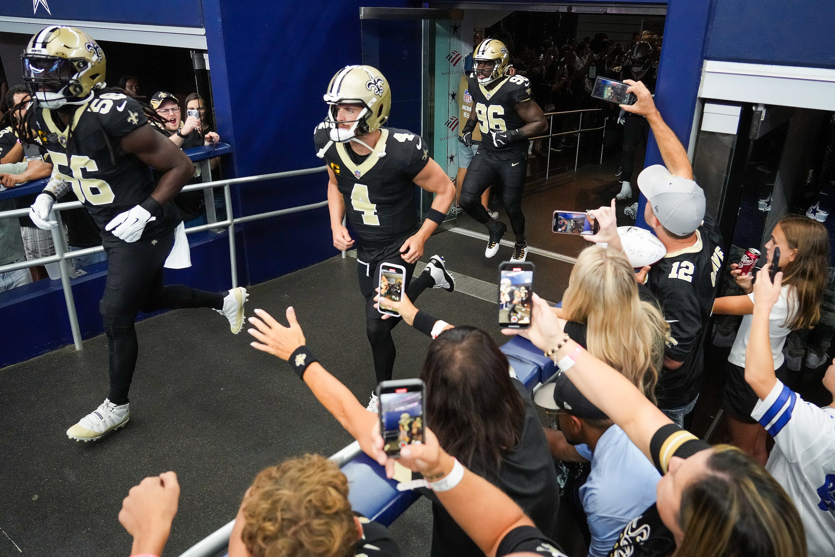 New Orleans Saints linebacker Demario Davis (56) and quarterback Derek Carr (4) lead their...