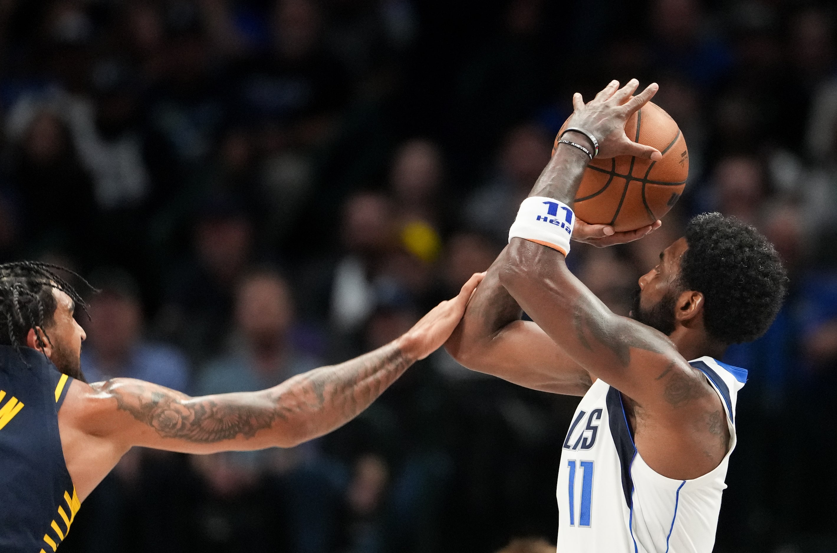 Dallas Mavericks guard Kyrie Irving (11) shoots as Indiana Pacers forward Obi Toppin (1)...