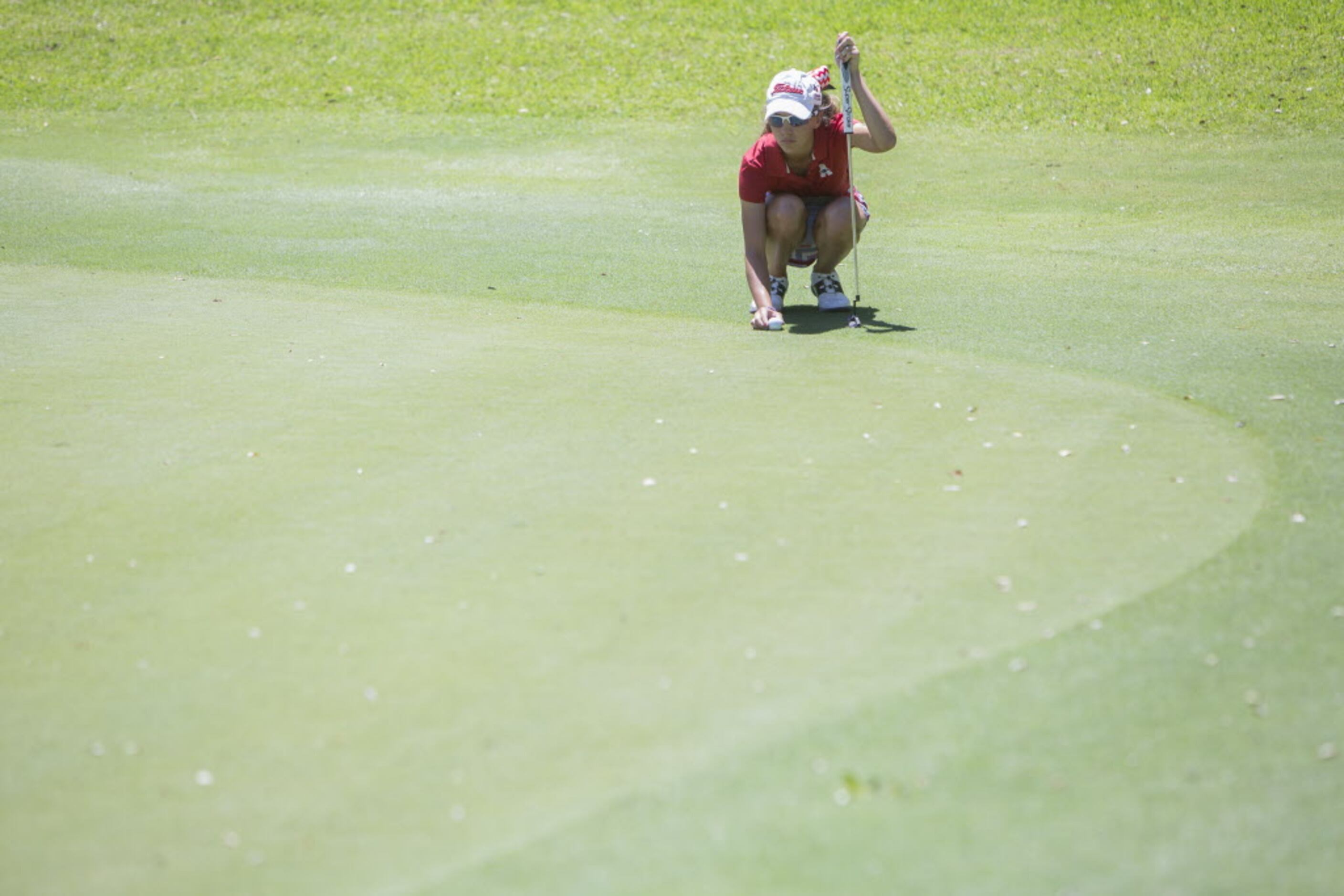 Allen junior Julie Houston lines up a putt on the second green during the UIL 5A State Golf...