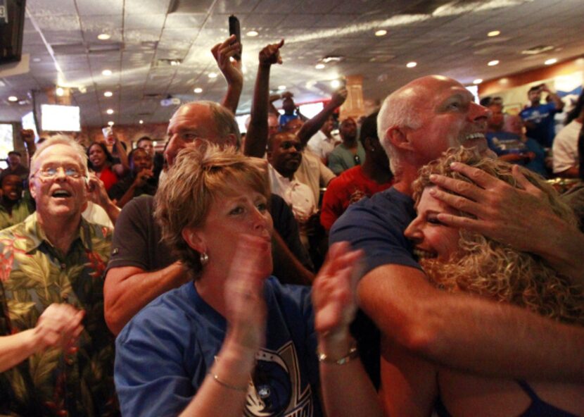 Dallas Mavericks fans at Champps in Addison, Texas erupt with joy when the Mavs won the NBA...