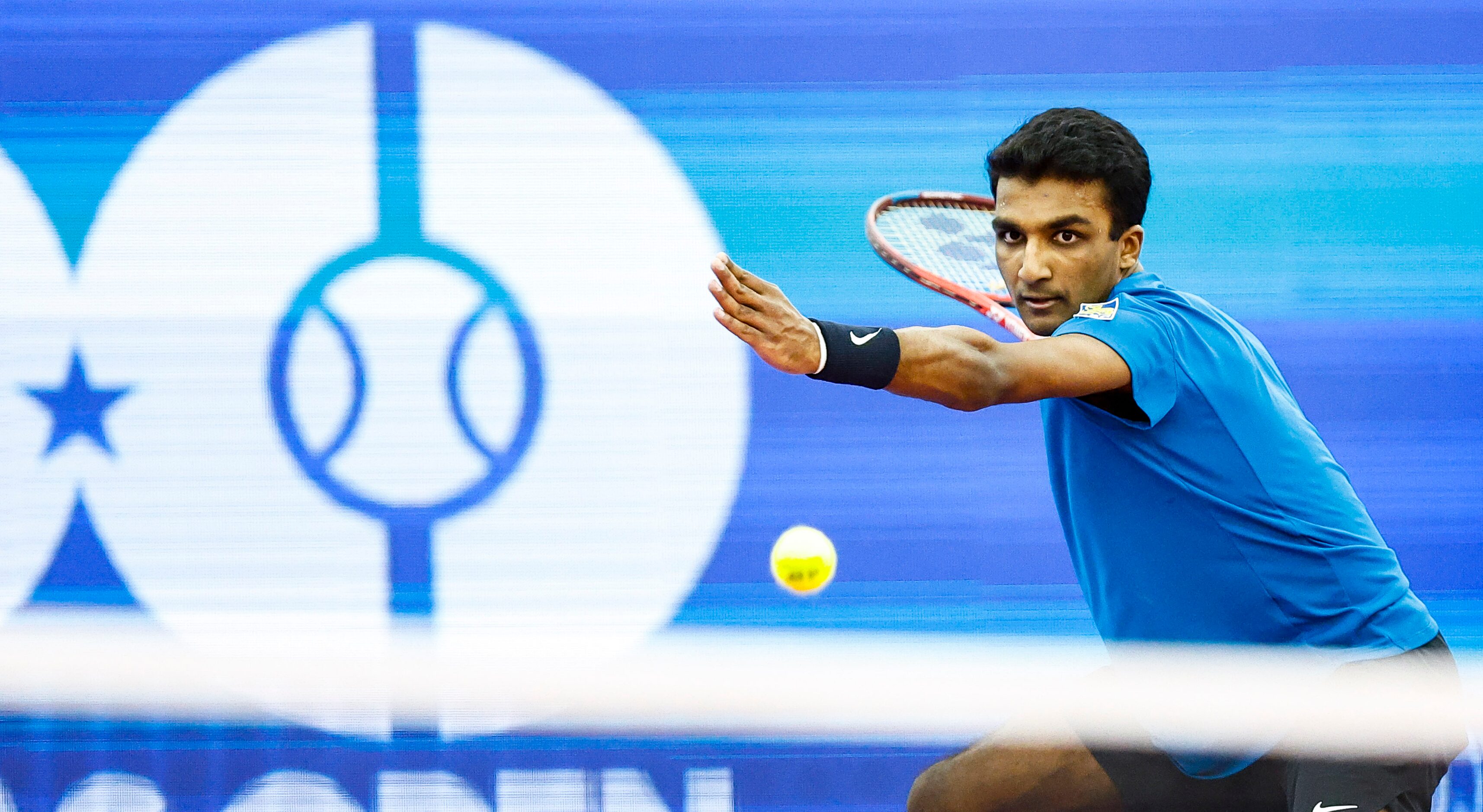 SMU senior Caleb Chakravarthi returns the ball in a match against Vasek Pospisil during the...