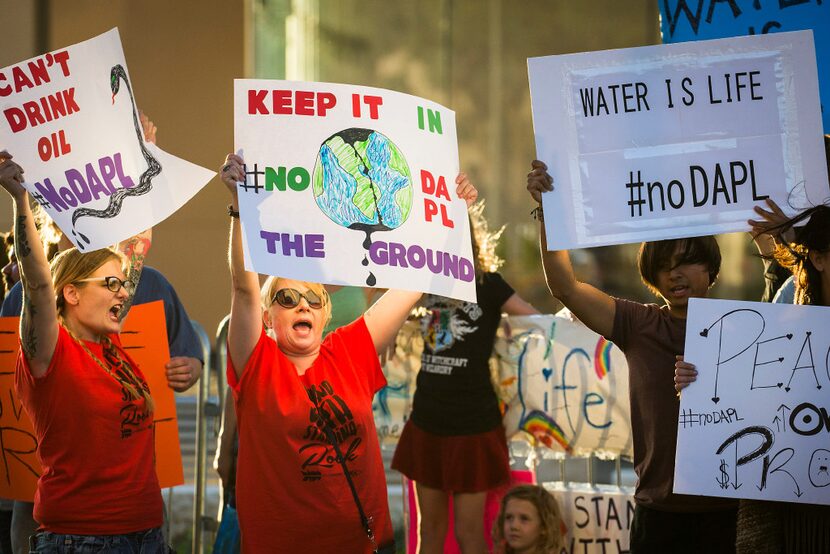 Marjoe Sweatt chants with other activists in November as they picket outside the offices of...