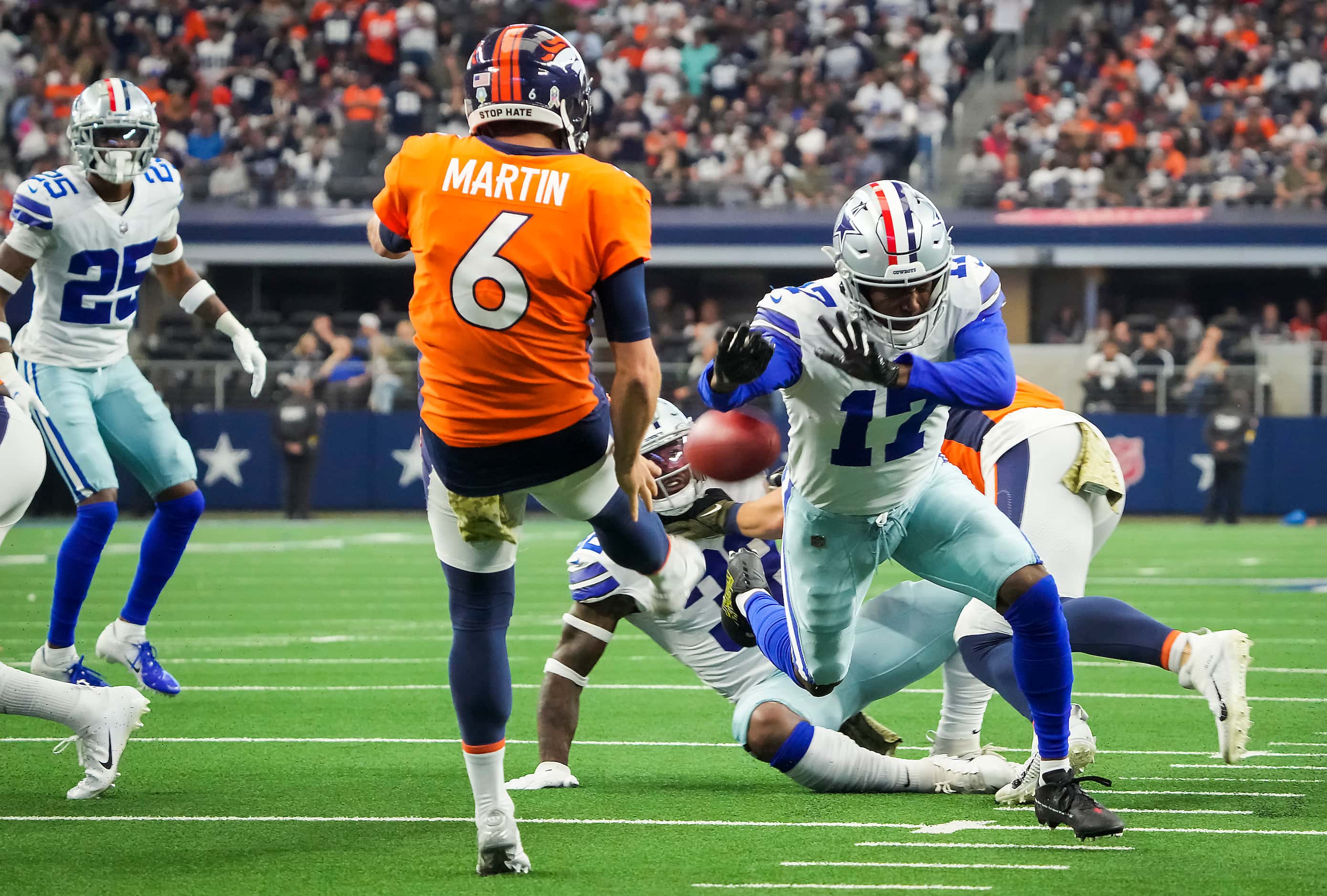 Dallas Cowboys wide receiver Malik Turner (17) blocks a punt by Denver Broncos punter Sam...