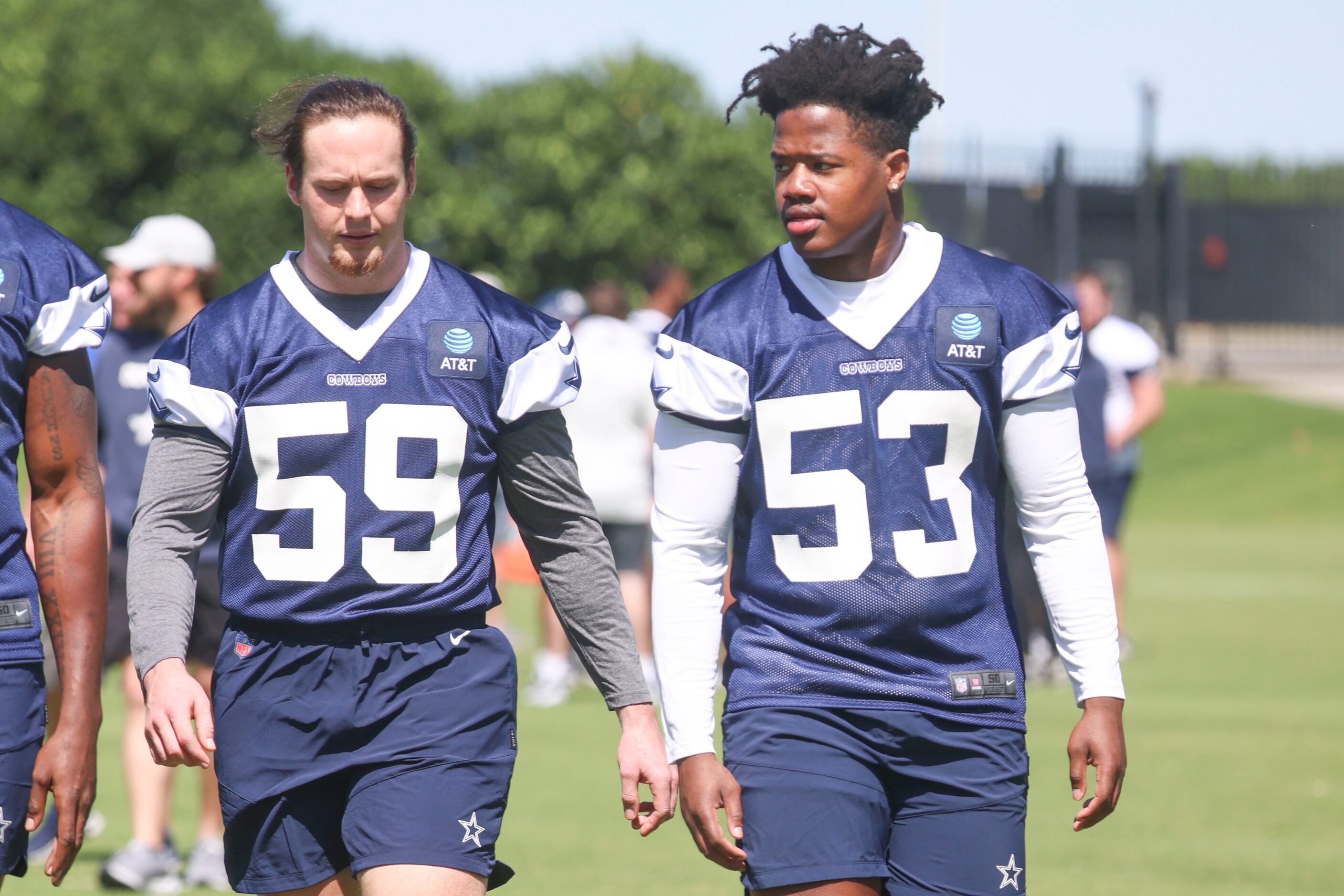 Dallas Cowboys linebackers Brock Mogensen (59), and Jason Johnson (53) exit the field during...