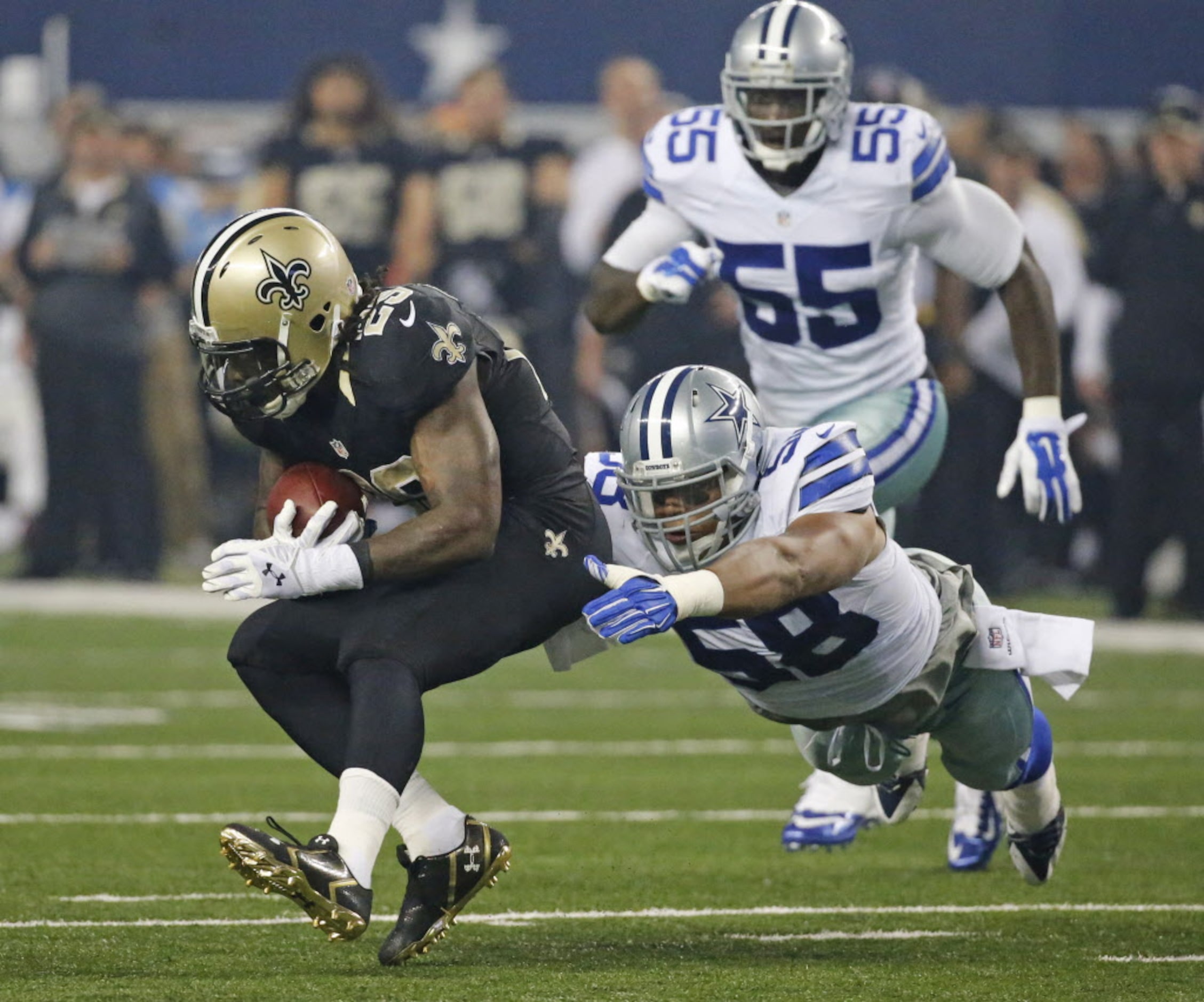 Dallas Cowboys defensive end Jack Crawford (58) tackles New Orleans Saints running back...