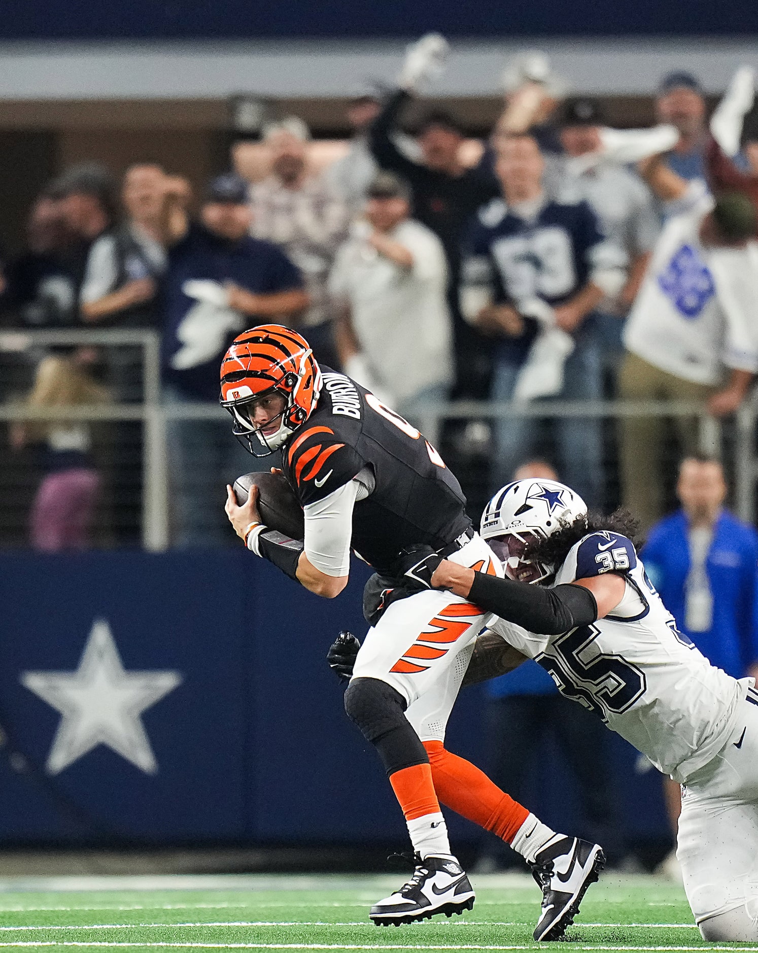 Cincinnati Bengals quarterback Joe Burrow (9) is sacked by Dallas Cowboys linebacker Marist...