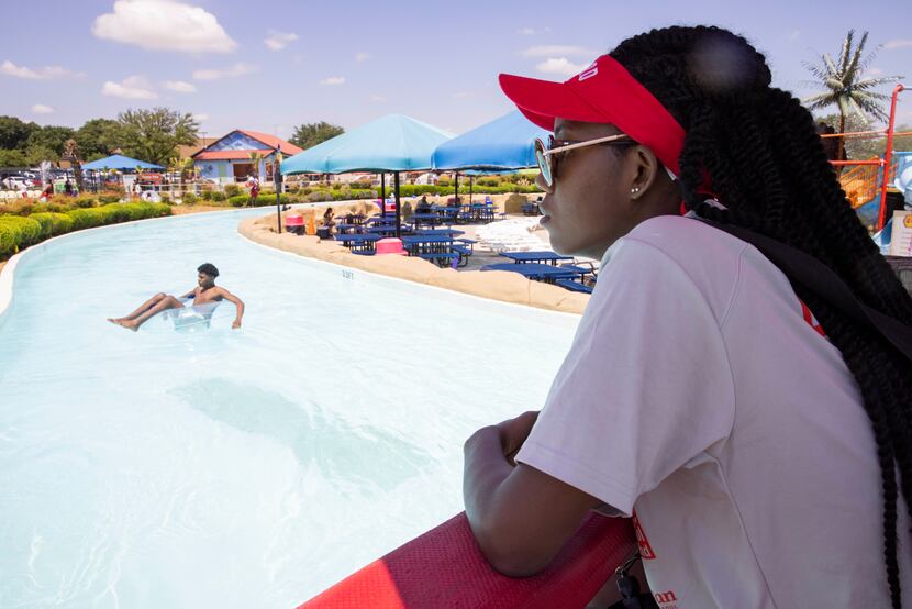 Lifeguard Hope Hart keeps an eye on swimmers at Bahama Beach in Dallas. The water park has...